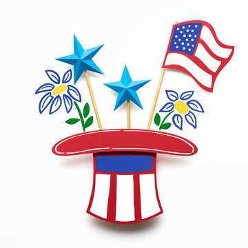 Happy 4th of July / Creative 4th of July concept photo of a hat with stars and flags made of paper on white background.