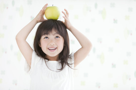 Girl Balancing Apple On Head