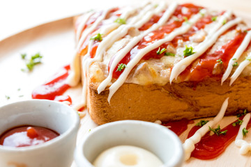 Pizza toasted bread with tomato sauce and ham cheese selective focus