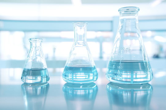 three size of blue glass flask in science laboratory
