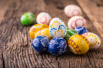 Easter. Hand made easter eggs on old wooden table.