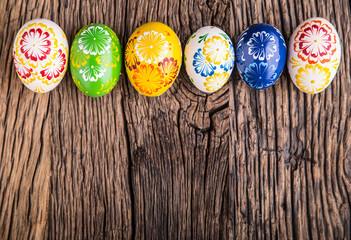 Easter. Hand made easter eggs on old wooden table.