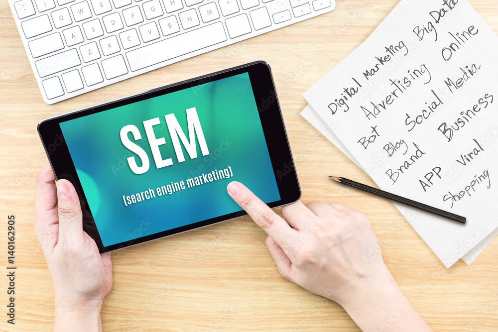 Poster hand using tablet with sem (search engine marketing ) word on screen with list of digital marketing 