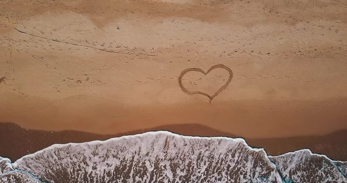 Be Happy - Aerial view of the beach and waves at sunset