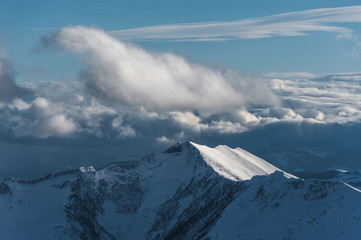 Fototapeta na wymiar Snowy winter mountains in sun day. Caucasus Mountains, Georgia, from ski resort Gudauri