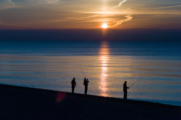 Happy man standing in Sea beach Sunset silhouette. Holiday vacation concept Copy space