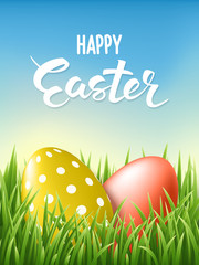 Happy Easter Lettering card whith decorated gold and red eggs at fresh green grass on blue sky background