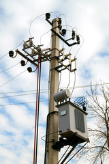 Distribution electrical transformer mounted on a pole. Electric utility. Distribution electrical...