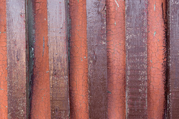 the background a few red boards are nailed to the shield