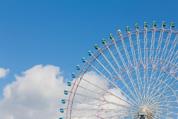 Ferris Wheel against blue sky background, amusement park
