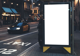 Blank advertising light box on bus stop, mockup of empty ad billboard on night bus station, template banner on background city street for message or text, afisha board and headlights of taxi cars