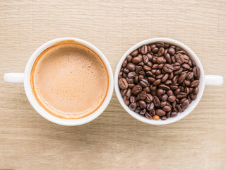 Top view of cup of latte and cup of coffee bean