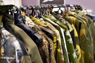 Fototapeta premium Jackets for hunting and fishing on hanger in store