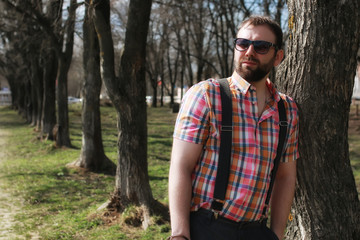 man beard suspender tree park sunglasses