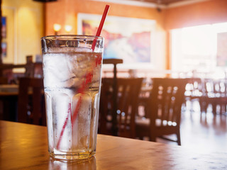 glass of water on wood table in restaurant
