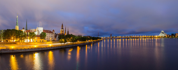 Panoramic view of Old Town of Riga (Latvia) in the evening. The view from bridge over Daugava river.