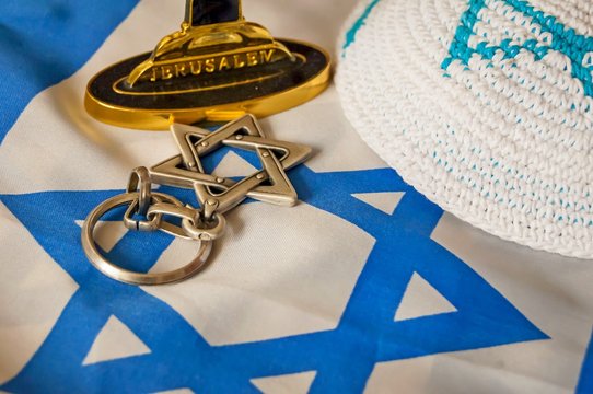 Jewish Symbols: Customary Religious Kippah Cap, A Star Of David And A Foundation Of A Menorah (a Seven-lamp Candelabrum) With The Word 