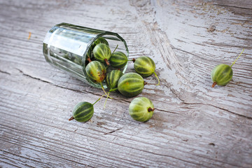 green gooseberries in a glass on the table
