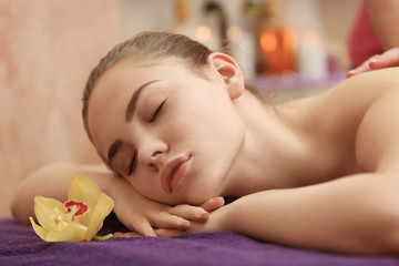 Fototapeta na wymiar Beautiful young woman having massage at spa salon