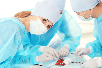 Young doctors operating patient in clinic