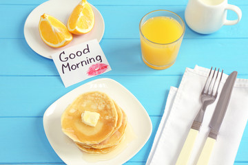 Tasty breakfast and note GOOD MORNING on kitchen table