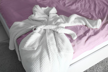 Spa bathrobe on bed