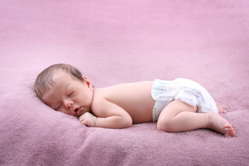 Cute little baby sleeping on bed at home
