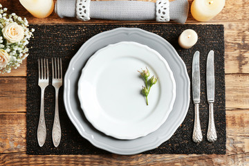 Beautiful festive table setting on wooden table