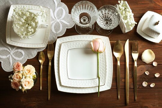 Beautiful festive table setting on wooden table
