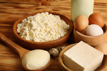 Different dairy products on wooden background