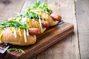 Beef hotdog  with mustard and arugula