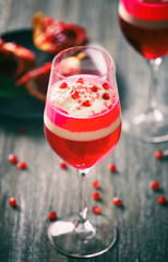 Layered dessert with decoration on wooden table