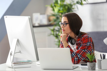 Young woman programmer working at office