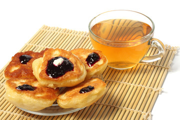fritters with jam with tea on wood   