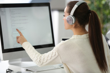 Young attractive programmer working at office