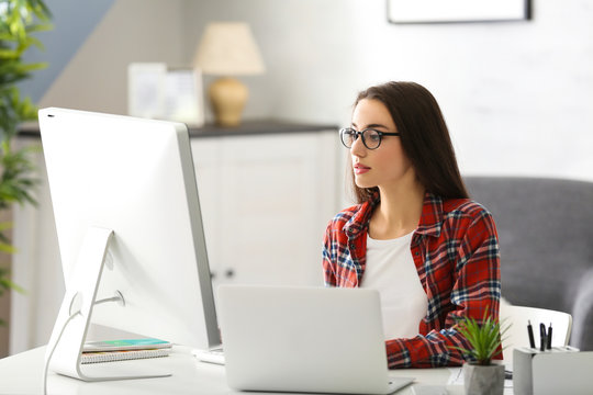 Young woman programmer working at office