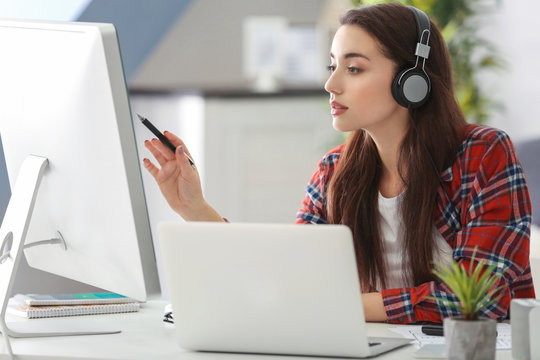 Young woman programmer working at office