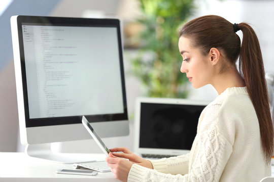 Young attractive programmer working at office