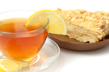 cup of tea with lemon and with cake isolated on white