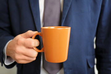 Man holding blank cup, closeup