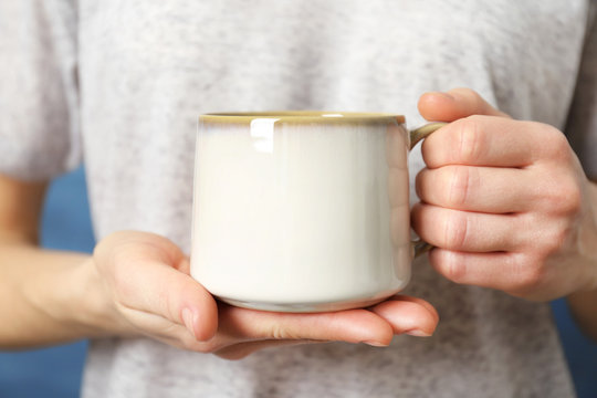 Blank white cup in hands, closeup
