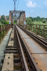 Fototapeta na wymiar old and rusty railway tracks and bridge