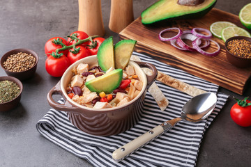 Chicken tortilla soup with vegetables on table