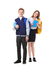 Teenagers with backpacks and books standing on white background