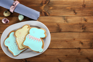 Beautiful glazed Easter cookies on wooden table