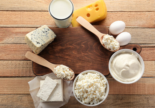 Composition of fresh dairy products on wooden table