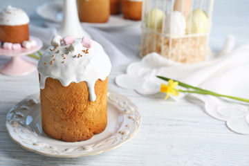 Plate with sweet Easter cake on table