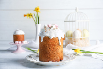 Plate with sweet Easter cake on table