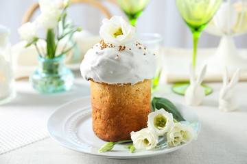 Plate with sweet Easter cake on table