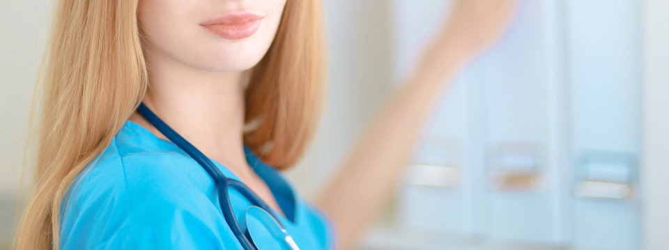 Doctor  woman is standing in the near window 